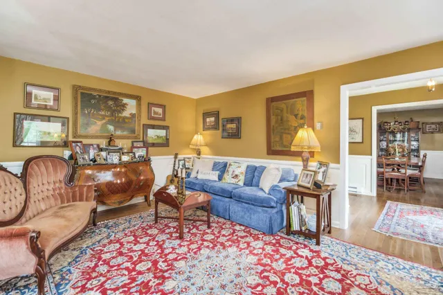 a bedroom with three beds and a chandelier