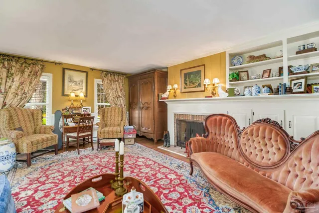 a bedroom with a bed a couch and a chandelier