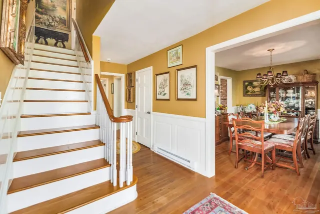 an aerial view of a house with swimming pool and outdoor seating