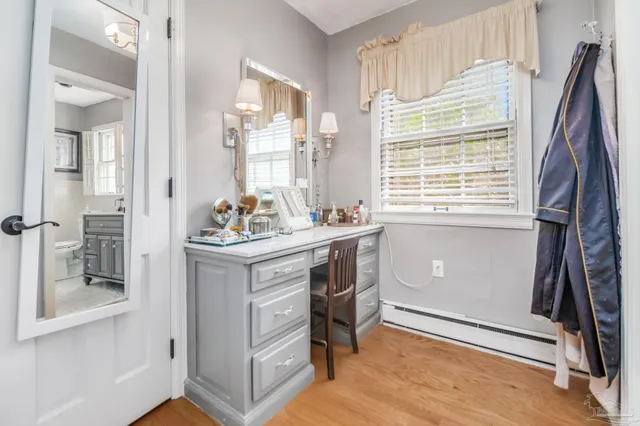 a kitchen with stainless steel appliances a stove a refrigerator cabinets and dining table