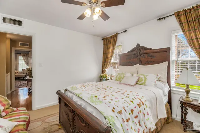 a living room with furniture a rug and a chandelier