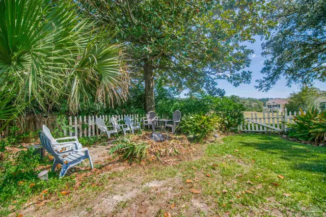 a view of a grassy field with trees