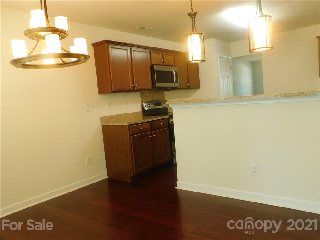 2602 Spring Breeze Way Monroe, NC 28110 - Photo 14 of 43 a view of a refrigerator in kitchen and wooden floor