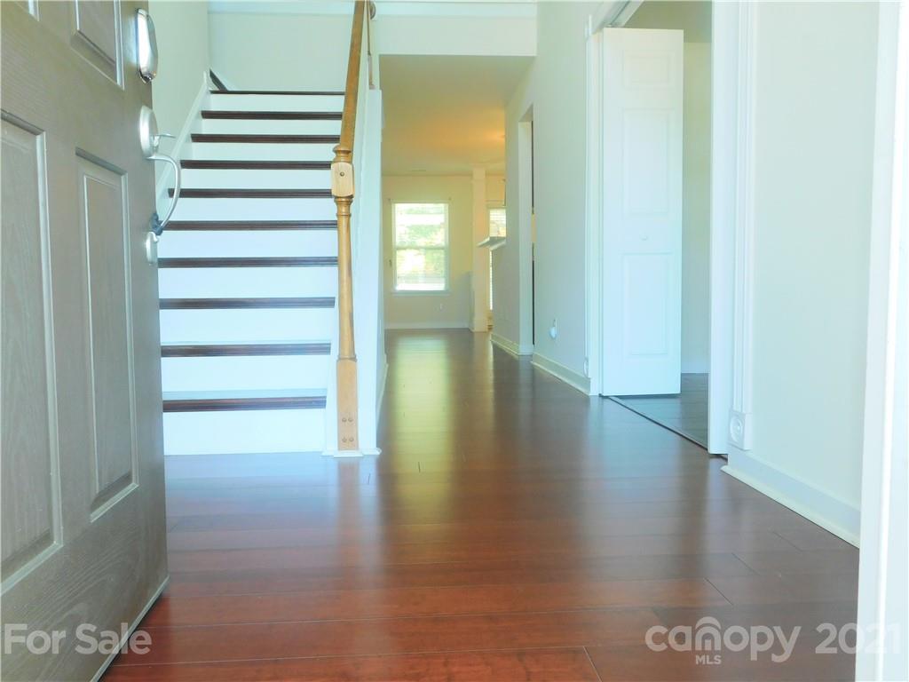 2602 Spring Breeze Way Monroe, NC 28110 - Photo 3 of 43 a view of a hallway with wooden floor
