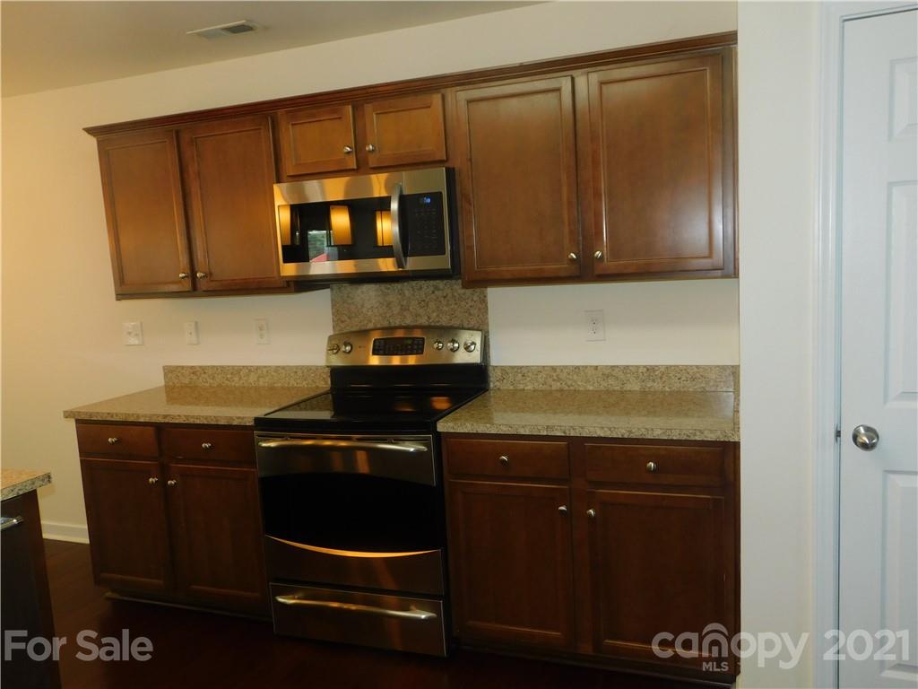2602 Spring Breeze Way Monroe, NC 28110 - Photo 8 of 43 a kitchen with a stove and a microwave