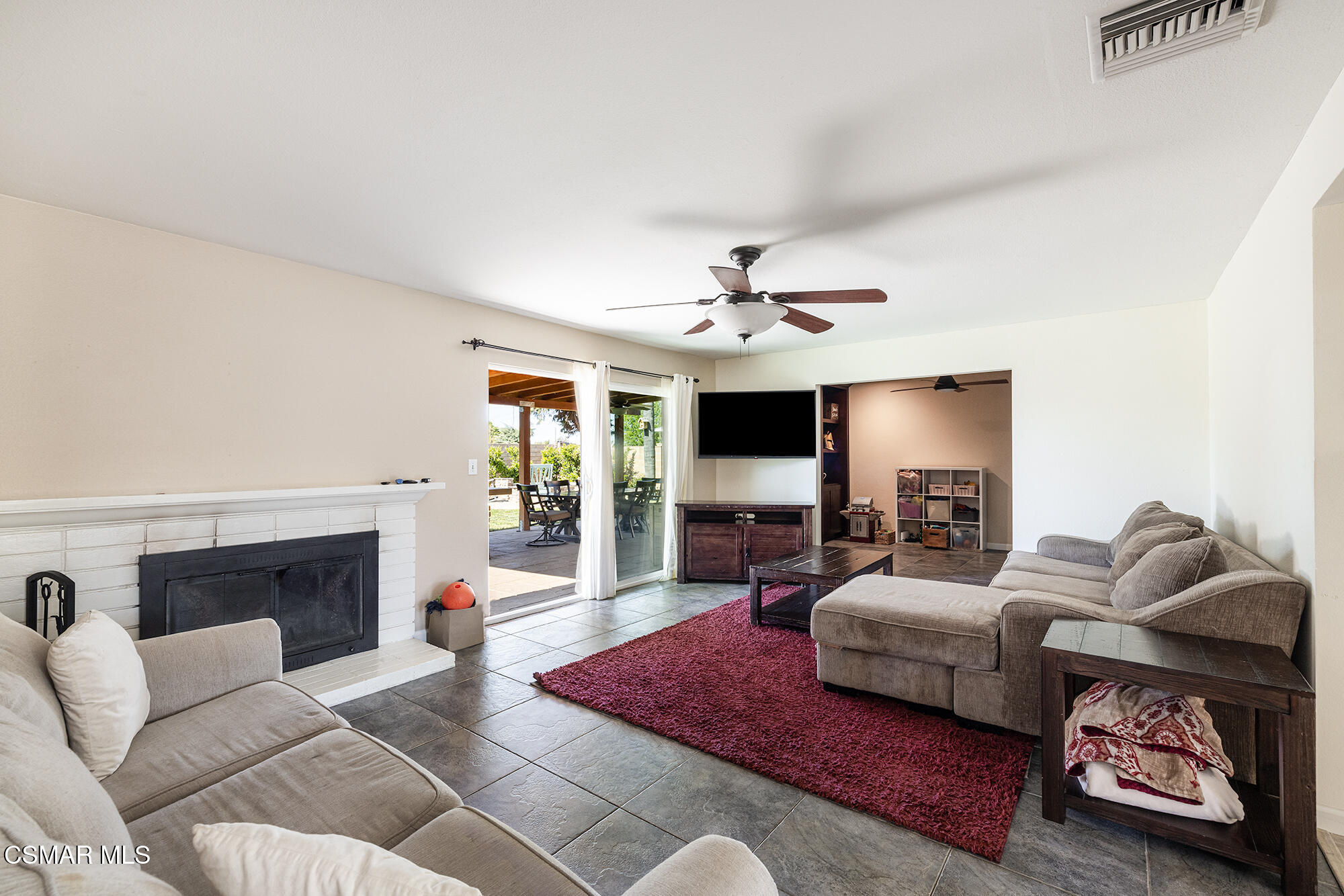 4828 Walnut Avenue Simi Valley, CA 93063 - Photo 12 of 25 a living room with furniture a fireplace and a flat screen tv