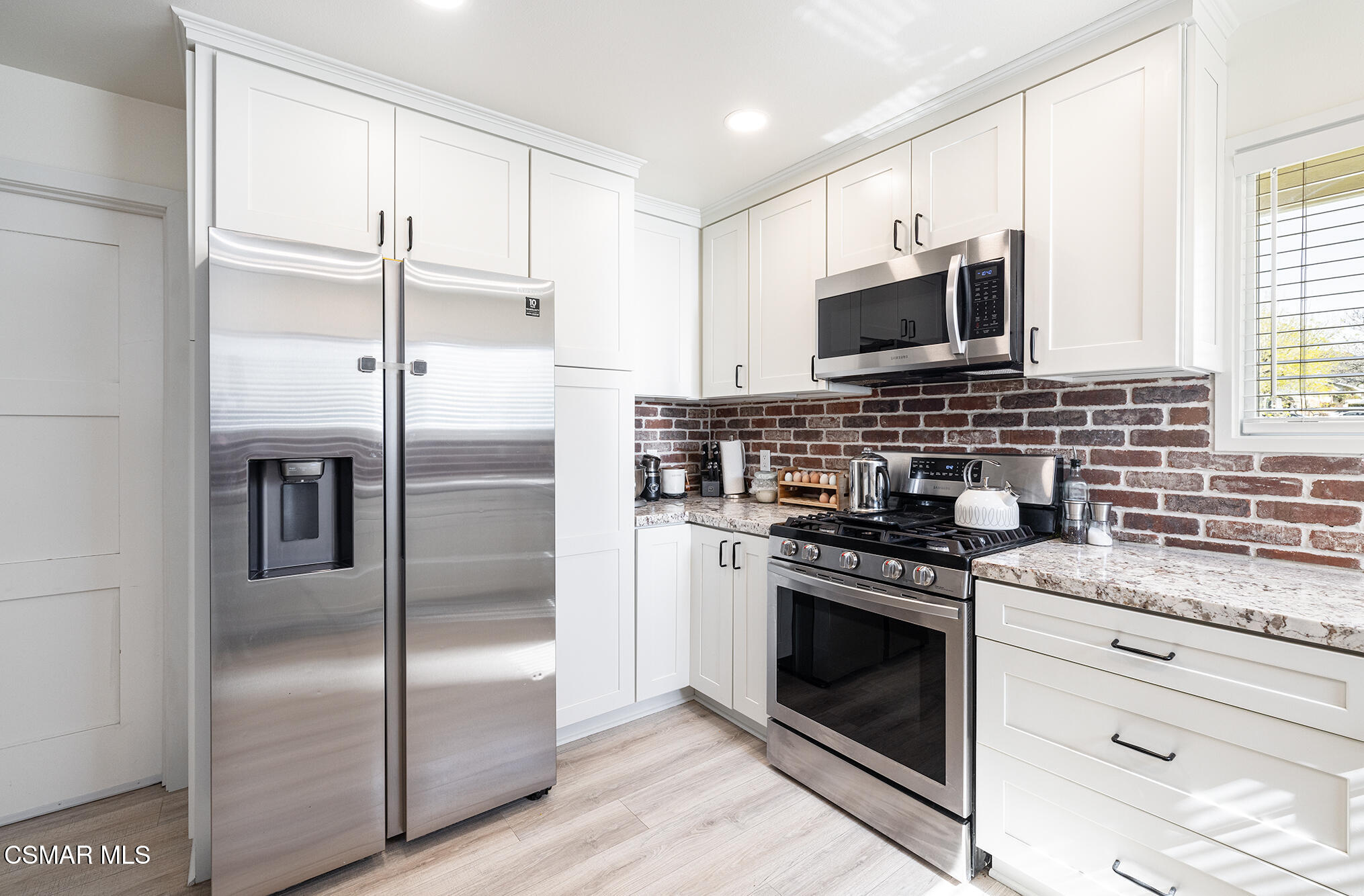 4828 Walnut Avenue Simi Valley, CA 93063 - Photo 8 of 25 a kitchen with stainless steel appliances granite countertop a stove a refrigerator and a microwave