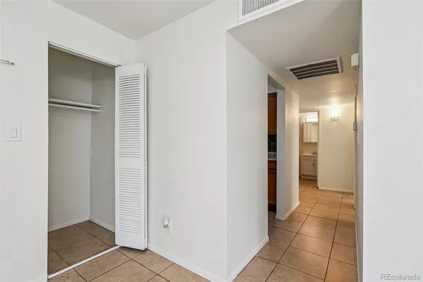 a view of a hallway with a wooden cabinets