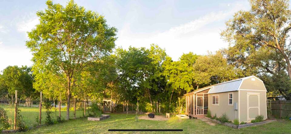 740 Trinity Street, Unit BACKYARD STUDIO Lockhart, TX 78644 - Photo 2 of 9 View of yard featuring 1/1 studio apartment with patio sunroom