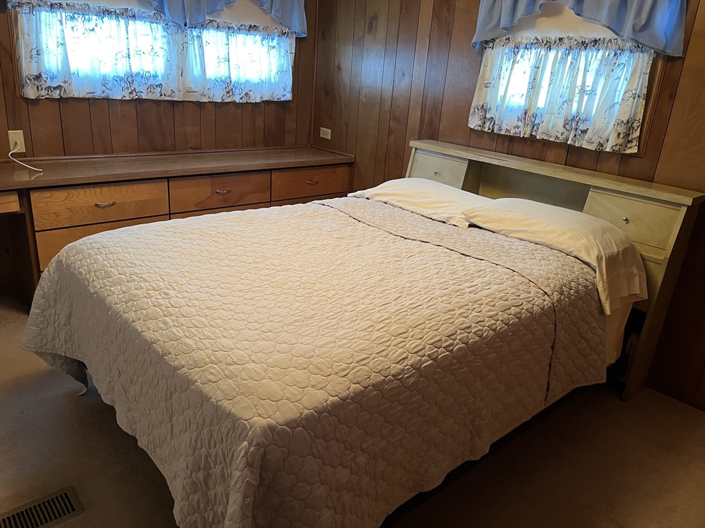 28 Mockingbird Drive Chicopee, MA 01020 - Photo 17 of 17 a bed sitting in a bedroom next to a window