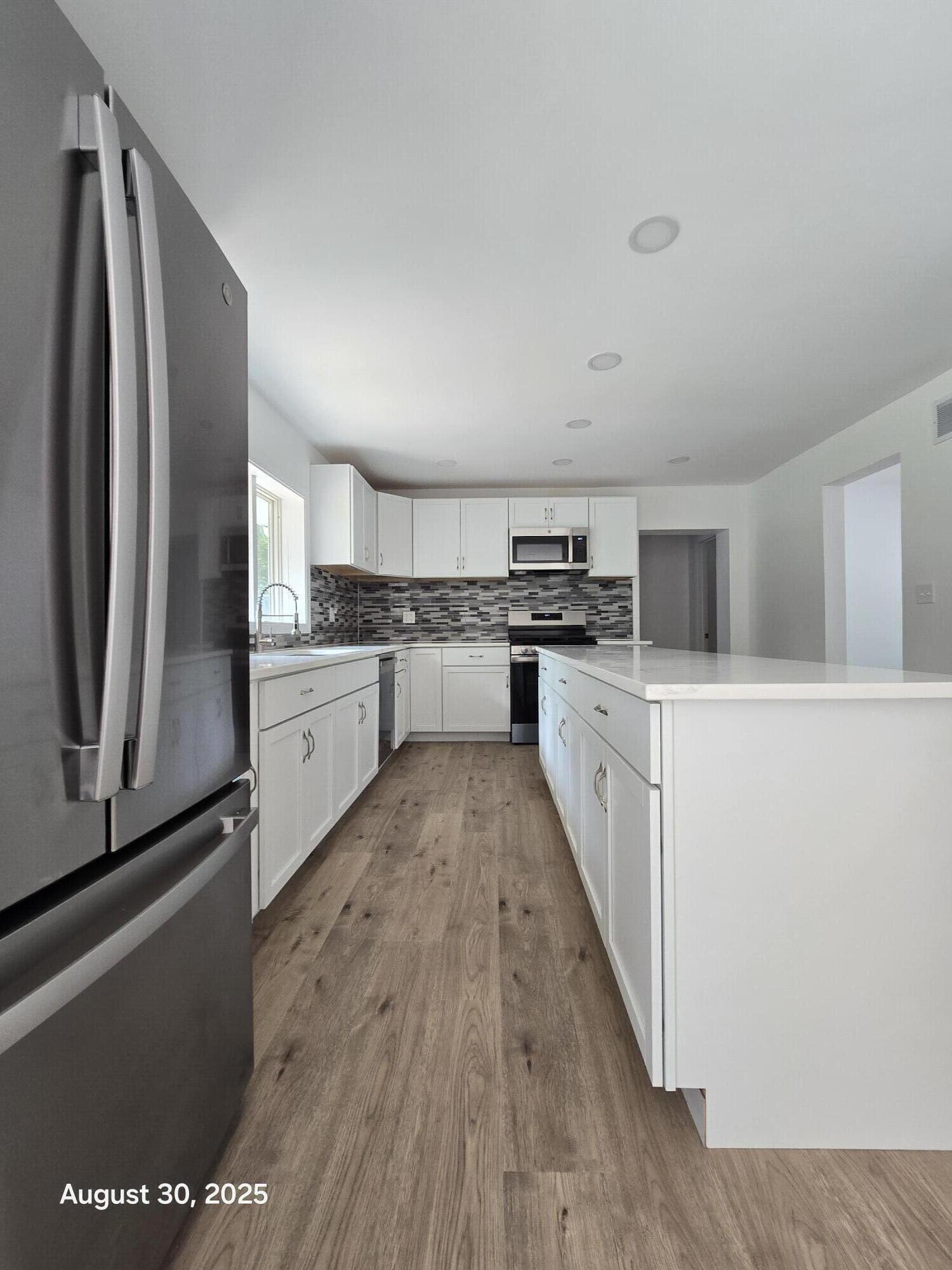 2345 Ranburn Drive Gary, IN 46408 - Photo 3 of 14 a large kitchen with cabinets and stainless steel appliances