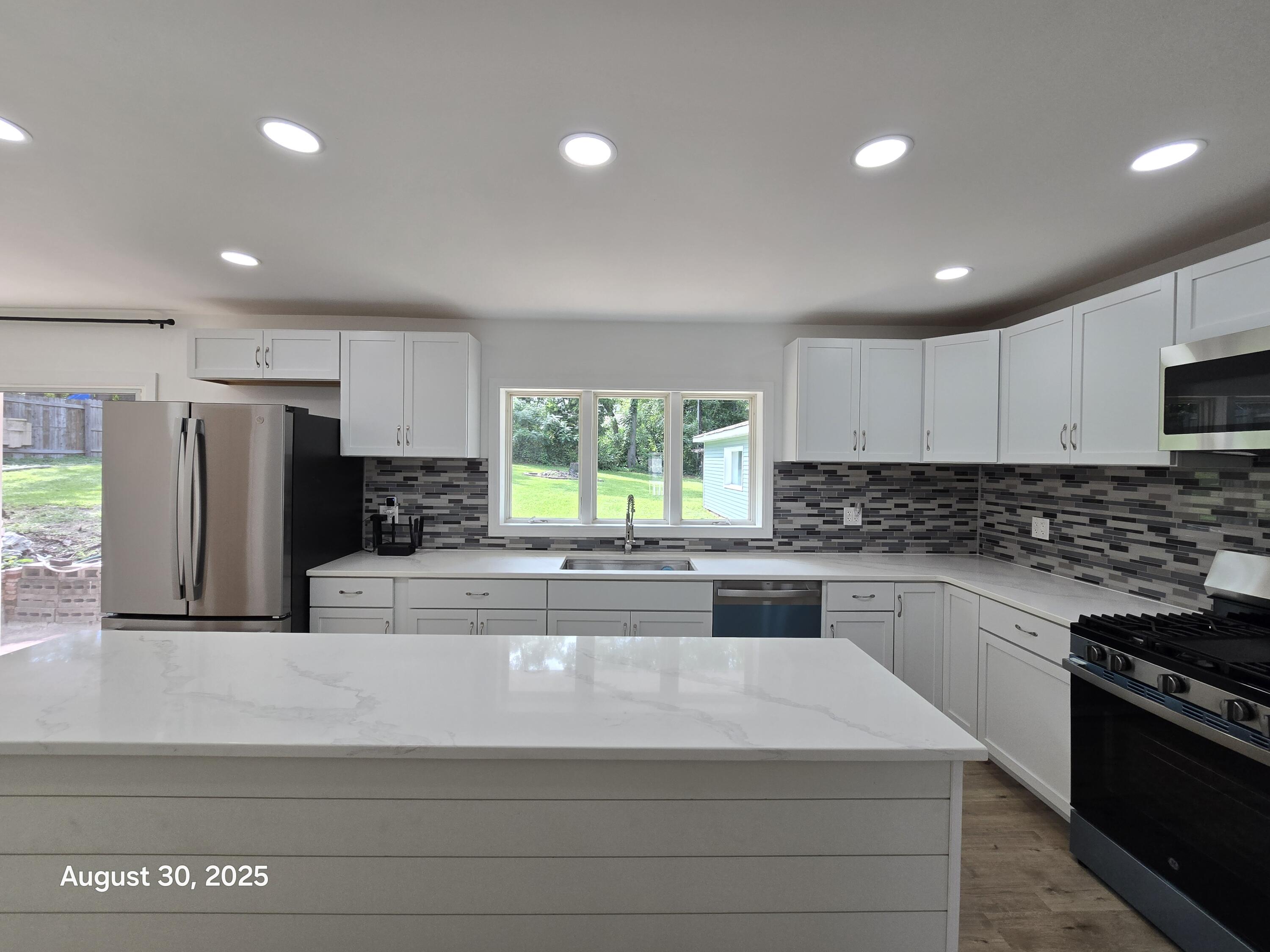 2345 Ranburn Drive Gary, IN 46408 - Photo 4 of 14 a large kitchen with stainless steel appliances granite countertop a stove a sink and a refrigerator