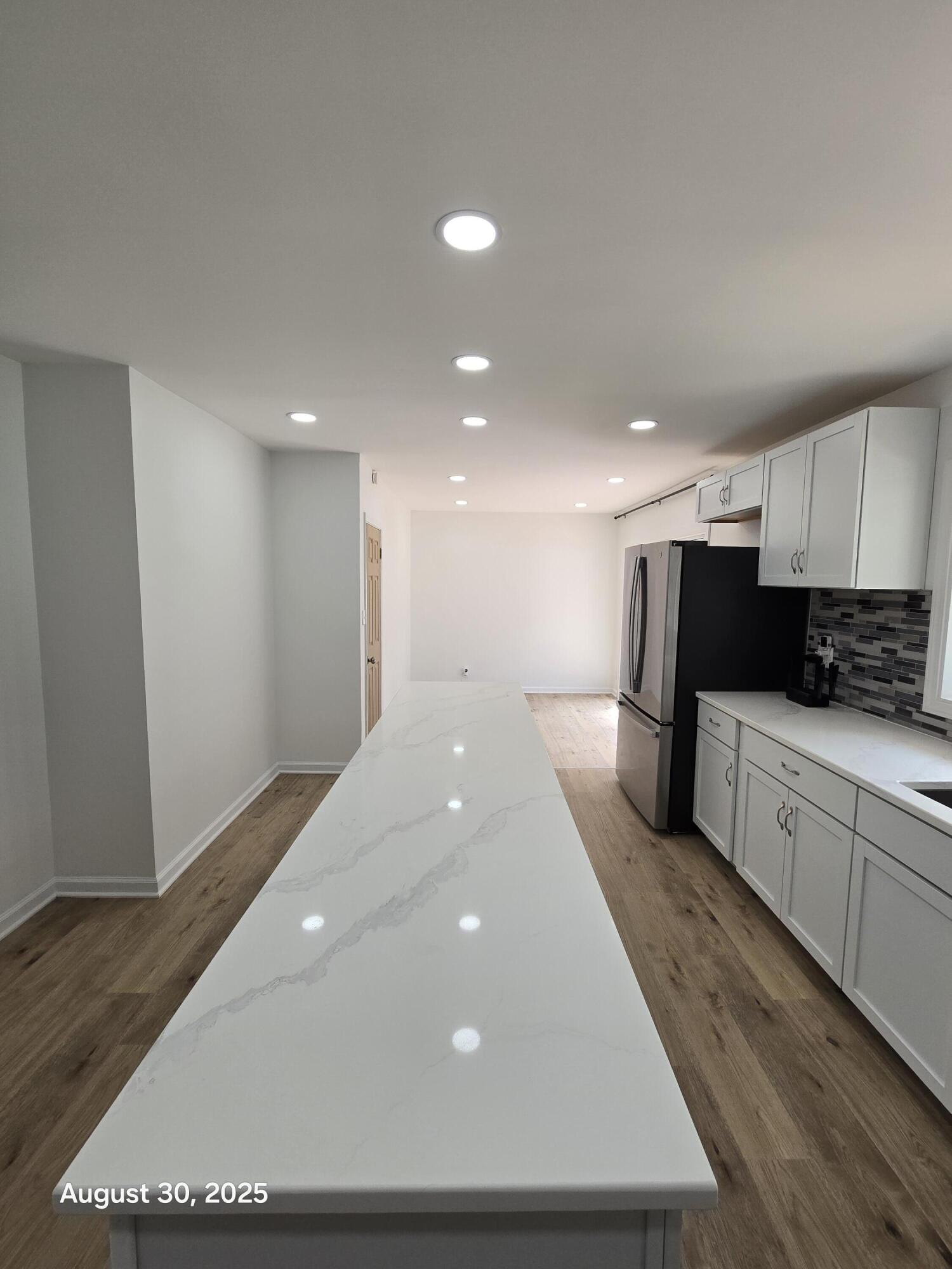 2345 Ranburn Drive Gary, IN 46408 - Photo 6 of 14 a large kitchen with stainless steel appliances a large counter top and a wooden floor