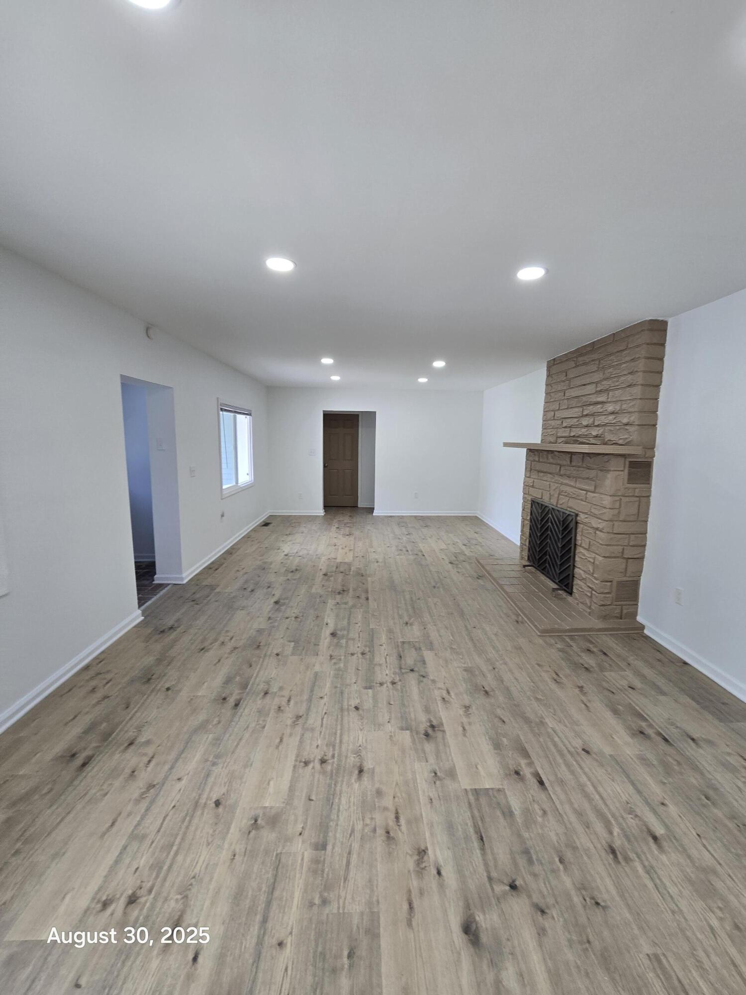 2345 Ranburn Drive Gary, IN 46408 - Photo 10 of 14 an empty room with wooden floor and fireplace