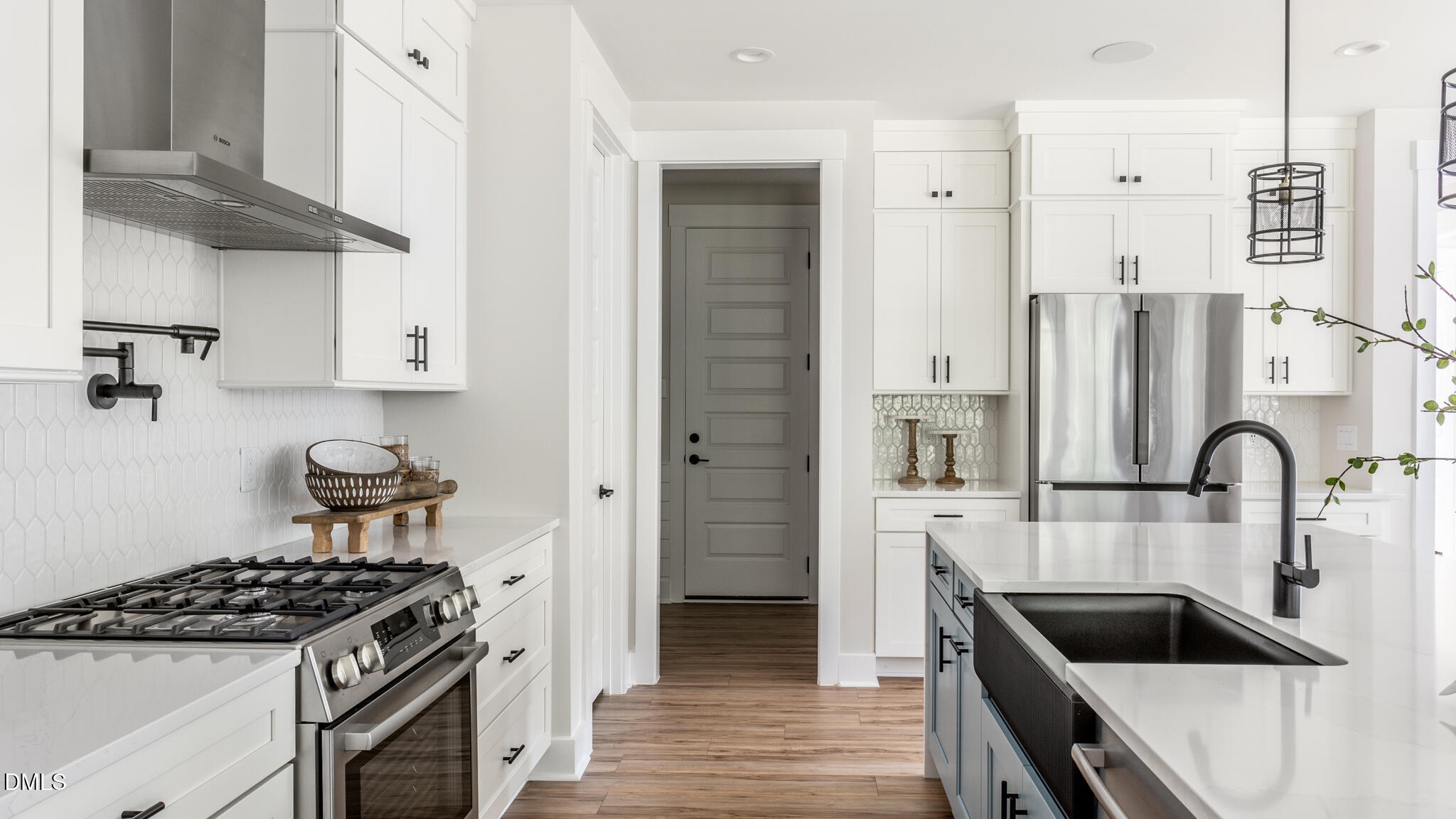 720 Fireship Road Fuquay-Varina, NC 27526 - Photo 12 of 16 a kitchen with stainless steel appliances granite countertop a sink stove and refrigerator