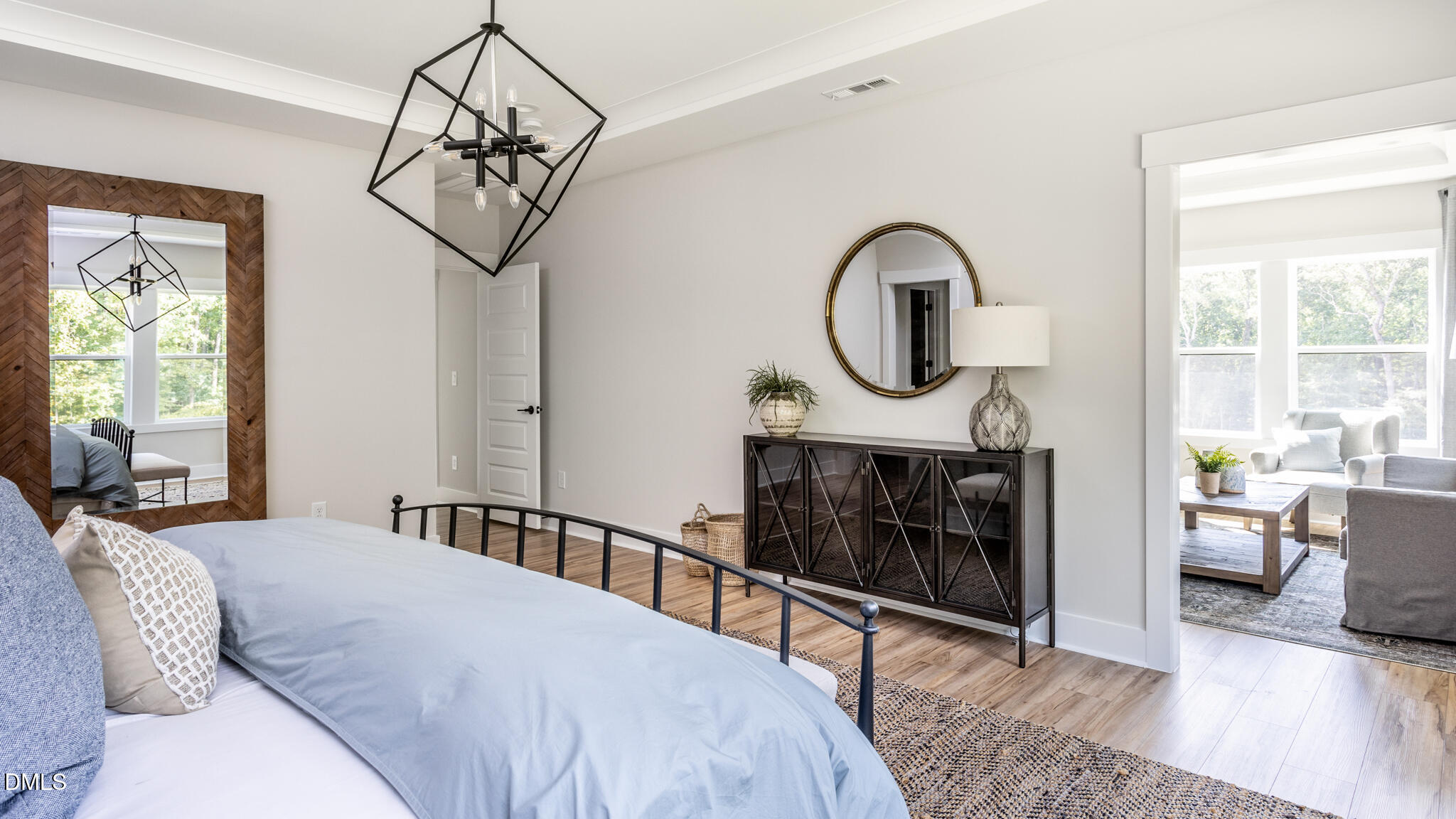 720 Fireship Road Fuquay-Varina, NC 27526 - Photo 14 of 16 a bedroom with a bed a chandelier and a window