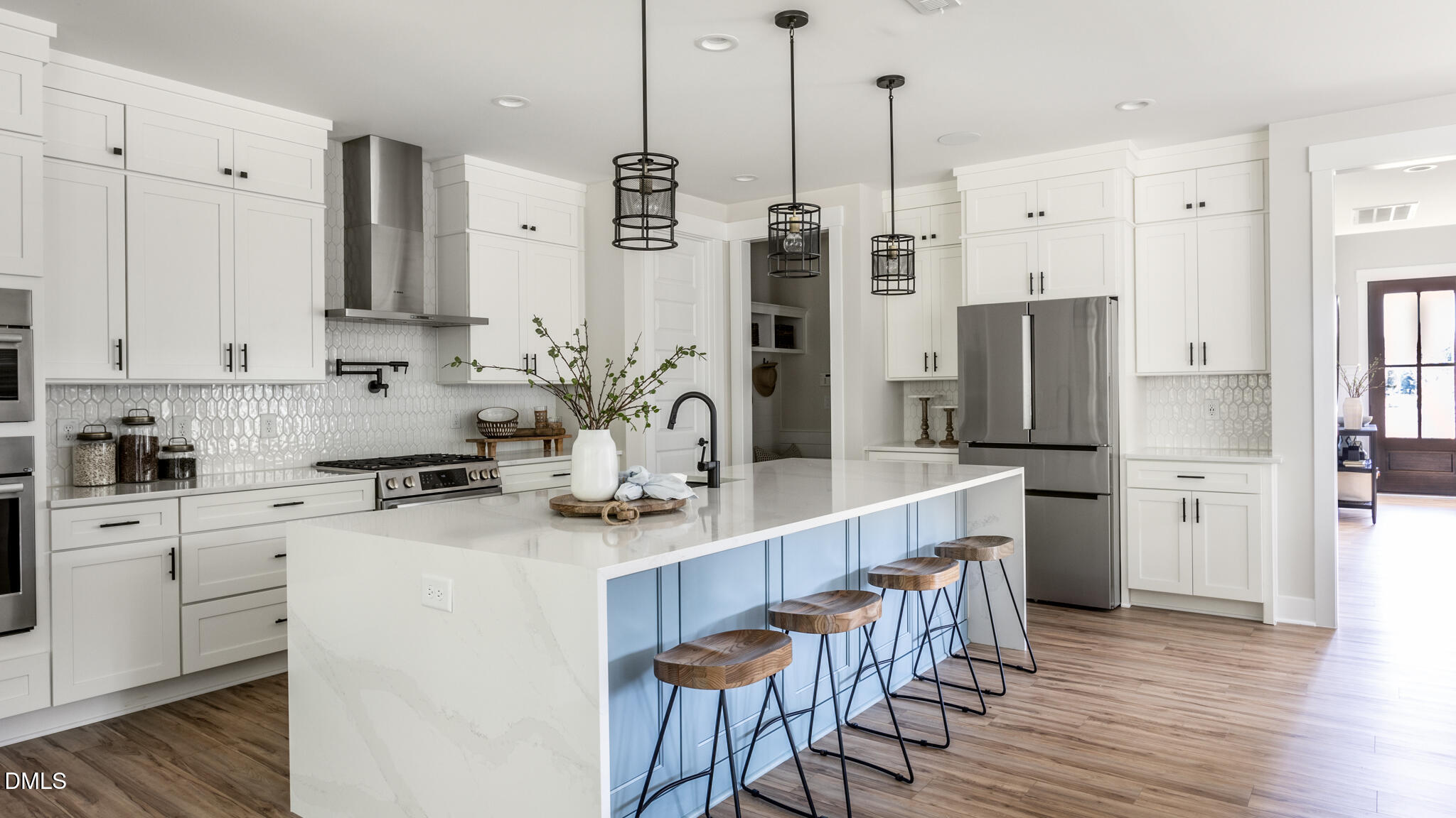 720 Fireship Road Fuquay-Varina, NC 27526 - Photo 3 of 16 a kitchen with stainless steel appliances kitchen island a refrigerator a stove a sink and chairs