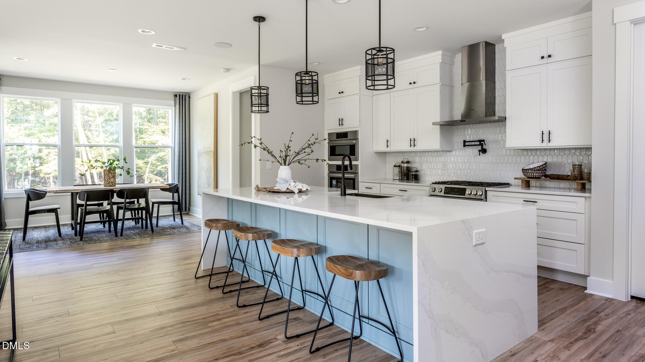 720 Fireship Road Fuquay-Varina, NC 27526 - Photo 10 of 16 a kitchen with stainless steel appliances a stove a sink a center island and a window