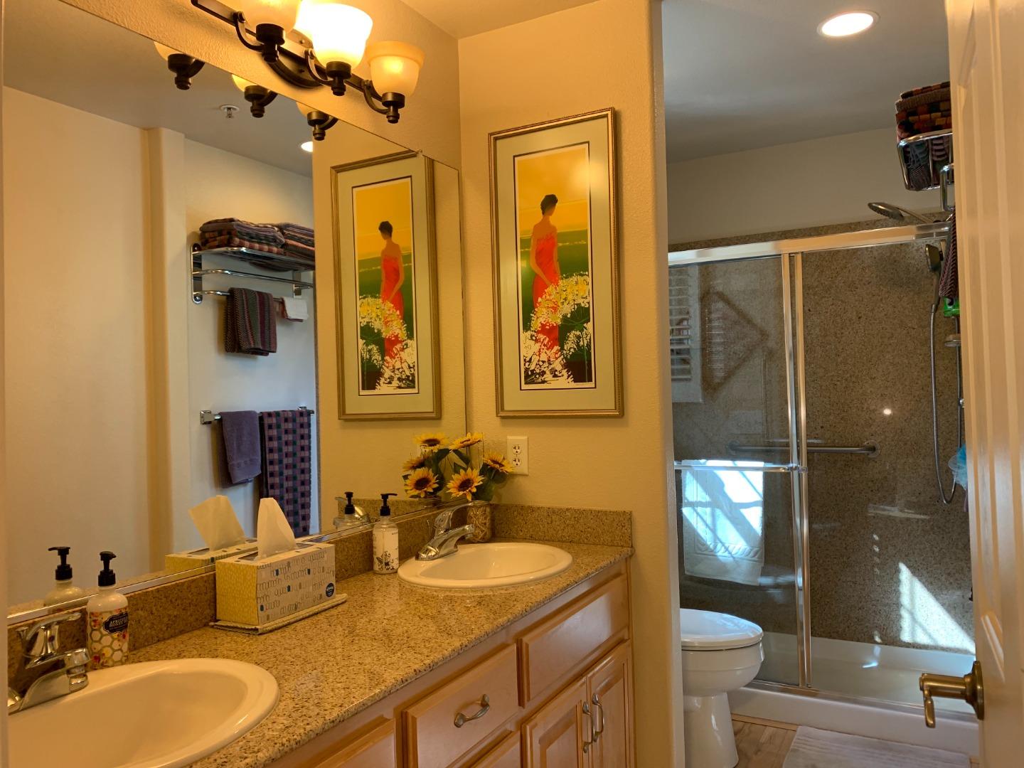 1554 Bianca Way Gilroy, CA 95020 - Photo 12 of 27 a bathroom with a granite countertop sink and a mirror
