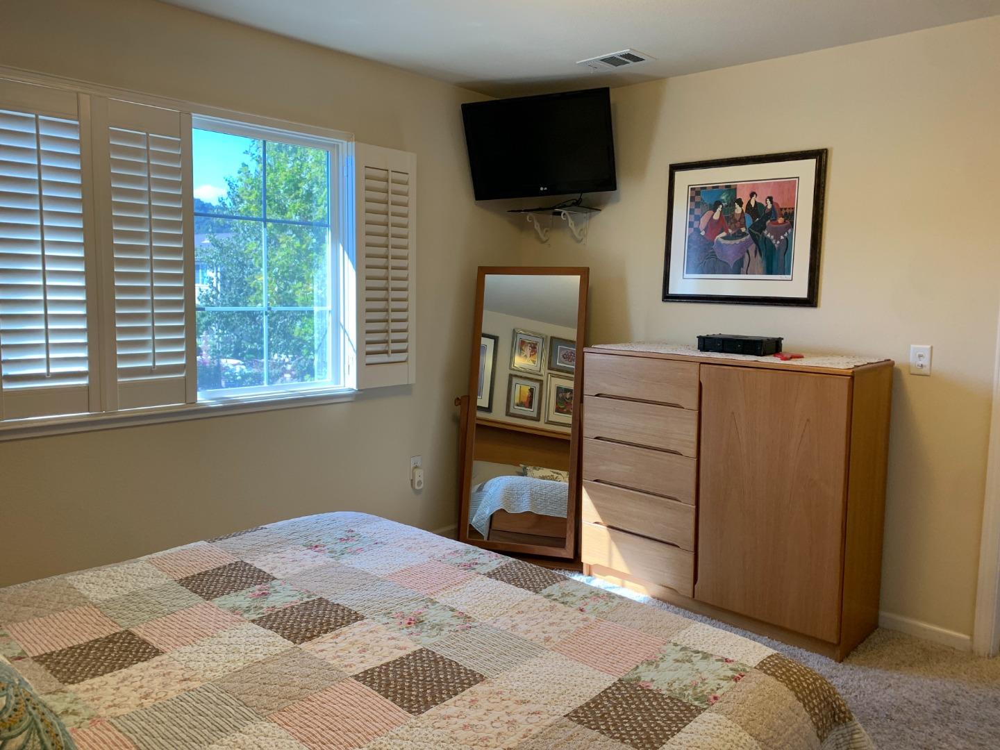 1554 Bianca Way Gilroy, CA 95020 - Photo 22 of 27 a bedroom with a bed and a flat screen tv