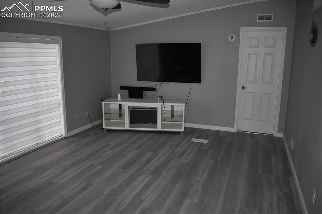 9250 County Road East Olney Springs, CO 81062 - Photo 21 of 32 a view of a livingroom with wooden floor and a flat screen tv