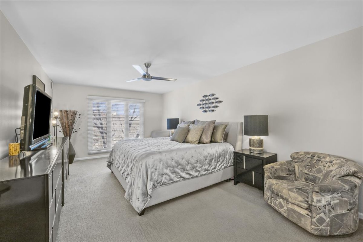 3741 Mission Hills Road, Unit 410 Northbrook, IL 60062 - Photo 15 of 21 a spacious bedroom with a bed and a flat screen tv