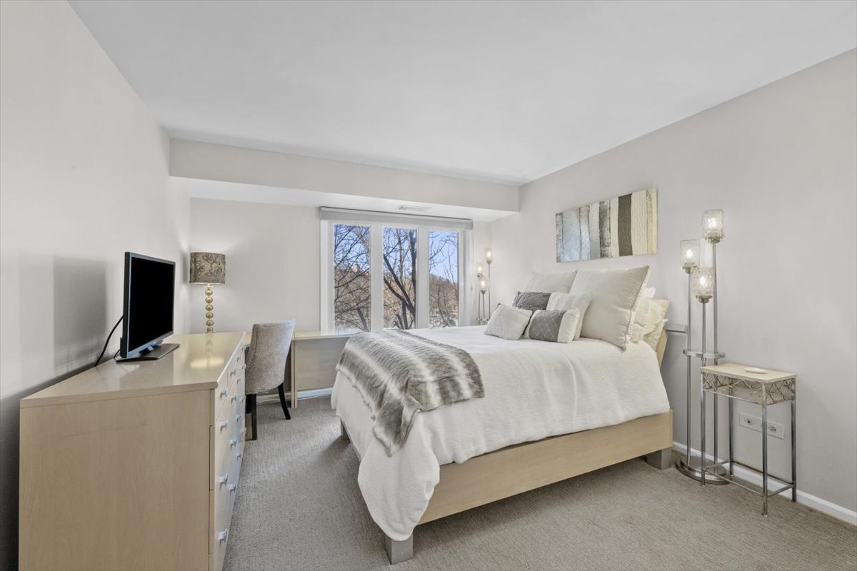 3741 Mission Hills Road, Unit 410 Northbrook, IL 60062 - Photo 20 of 21 a bedroom with a bed and a flat screen tv