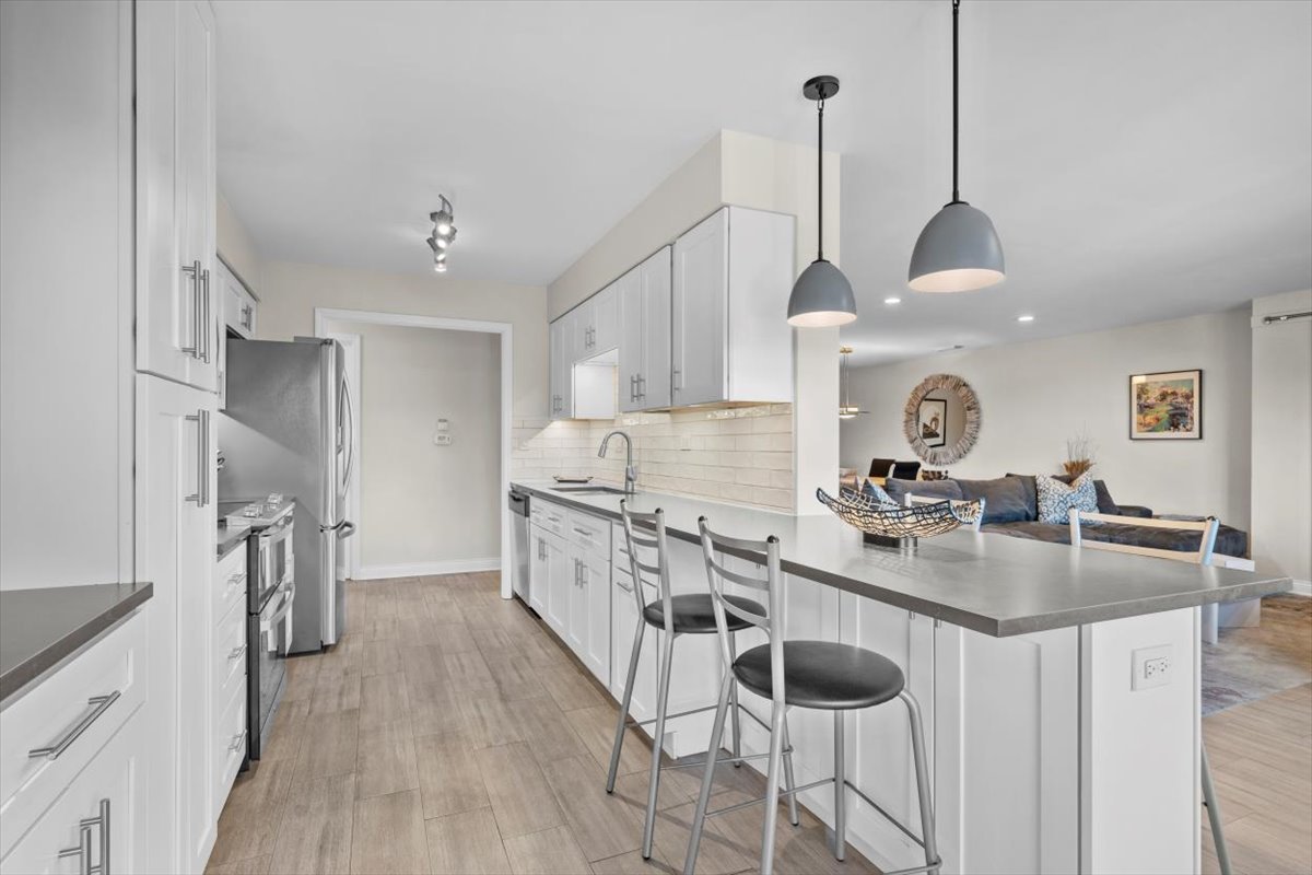 3741 Mission Hills Road, Unit 410 Northbrook, IL 60062 - Photo 3 of 21 a kitchen with sink refrigerator and cabinets