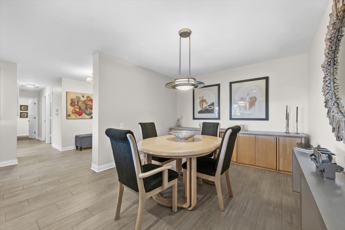 3741 Mission Hills Road, Unit 410 Northbrook, IL 60062 - Photo 8 of 21 a view of a dining room with furniture and wooden floor