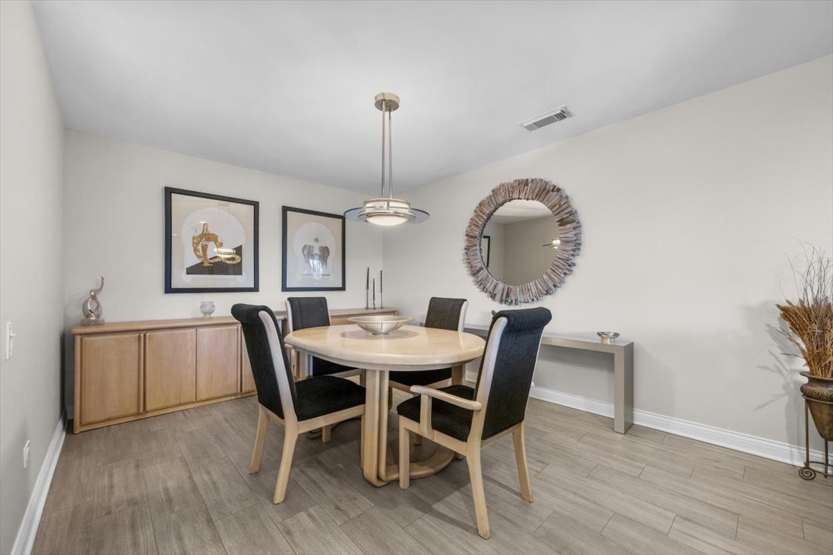 3741 Mission Hills Road, Unit 410 Northbrook, IL 60062 - Photo 9 of 21 a view of a dining room with furniture window and wooden floor