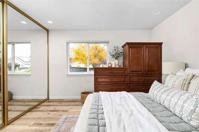 a bathroom with a granite countertop sink a toilet a mirror and shower