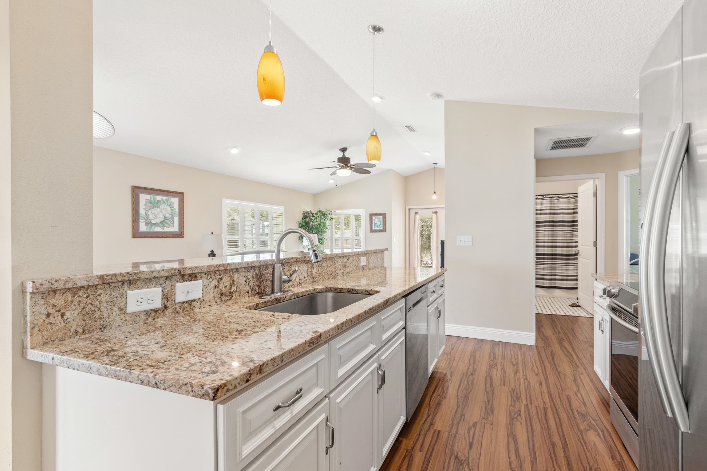 32 Comares Avenue St. Augustine, FL 32080 - Photo 15 of 43 a kitchen with stainless steel appliances granite countertop a sink and a refrigerator