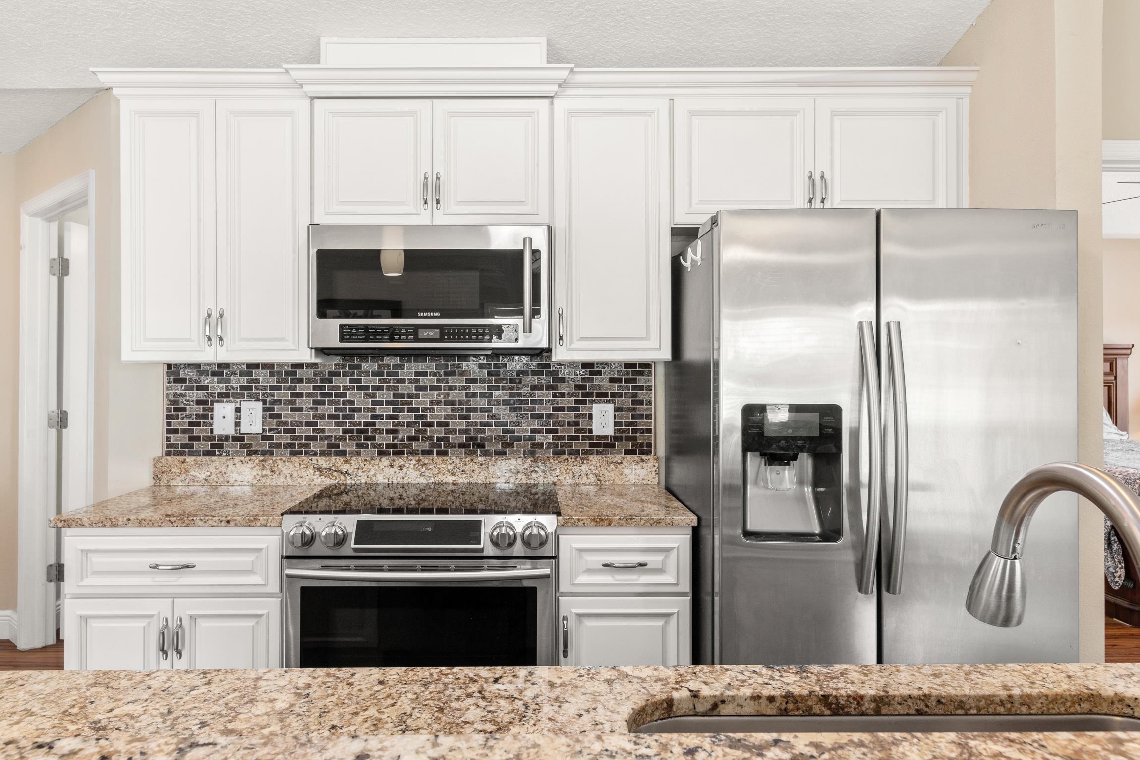 32 Comares Avenue St. Augustine, FL 32080 - Photo 16 of 43 a kitchen with granite countertop a stainless steel stove and refrigerator