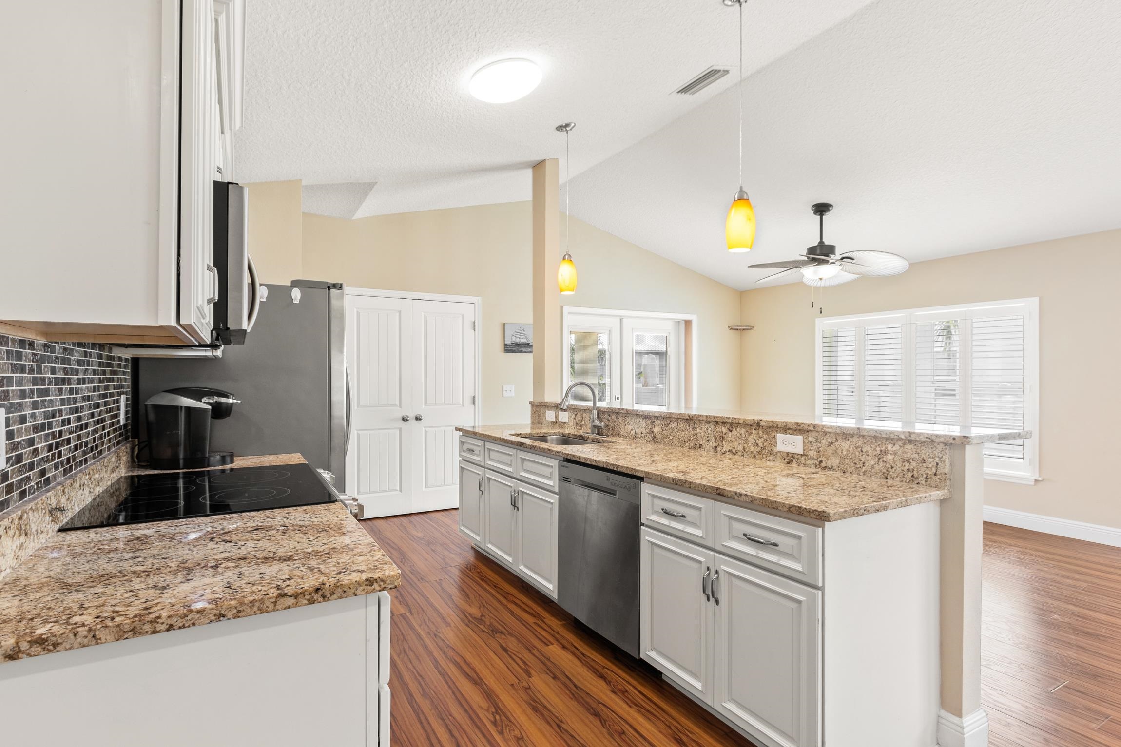 32 Comares Avenue St. Augustine, FL 32080 - Photo 17 of 43 a kitchen with stainless steel appliances granite countertop a sink stove and refrigerator