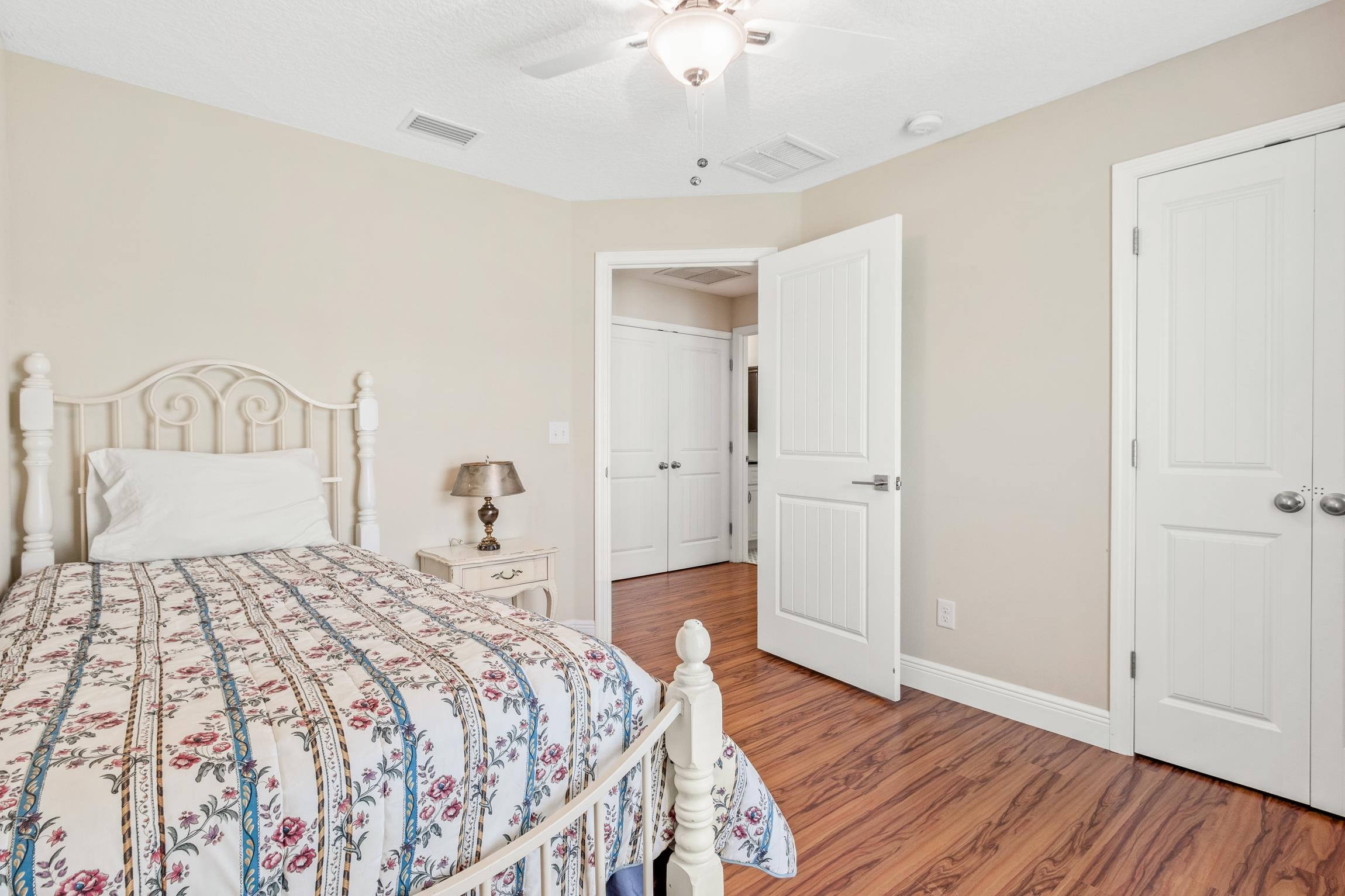 32 Comares Avenue St. Augustine, FL 32080 - Photo 22 of 43 a bedroom with a bed and wooden floor