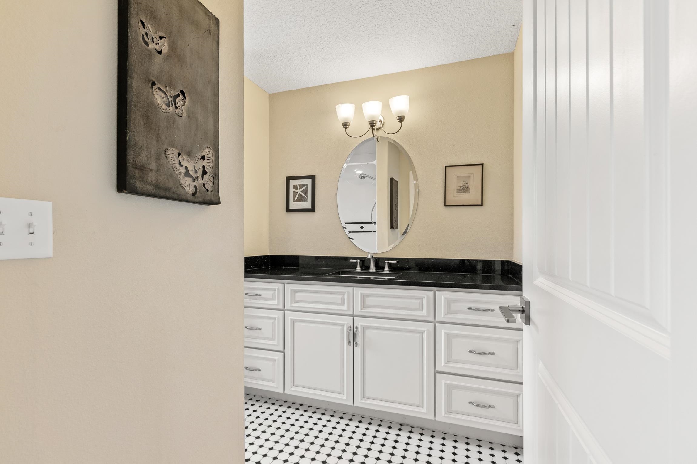 32 Comares Avenue St. Augustine, FL 32080 - Photo 25 of 43 a bathroom with a sink a vanity and a mirror
