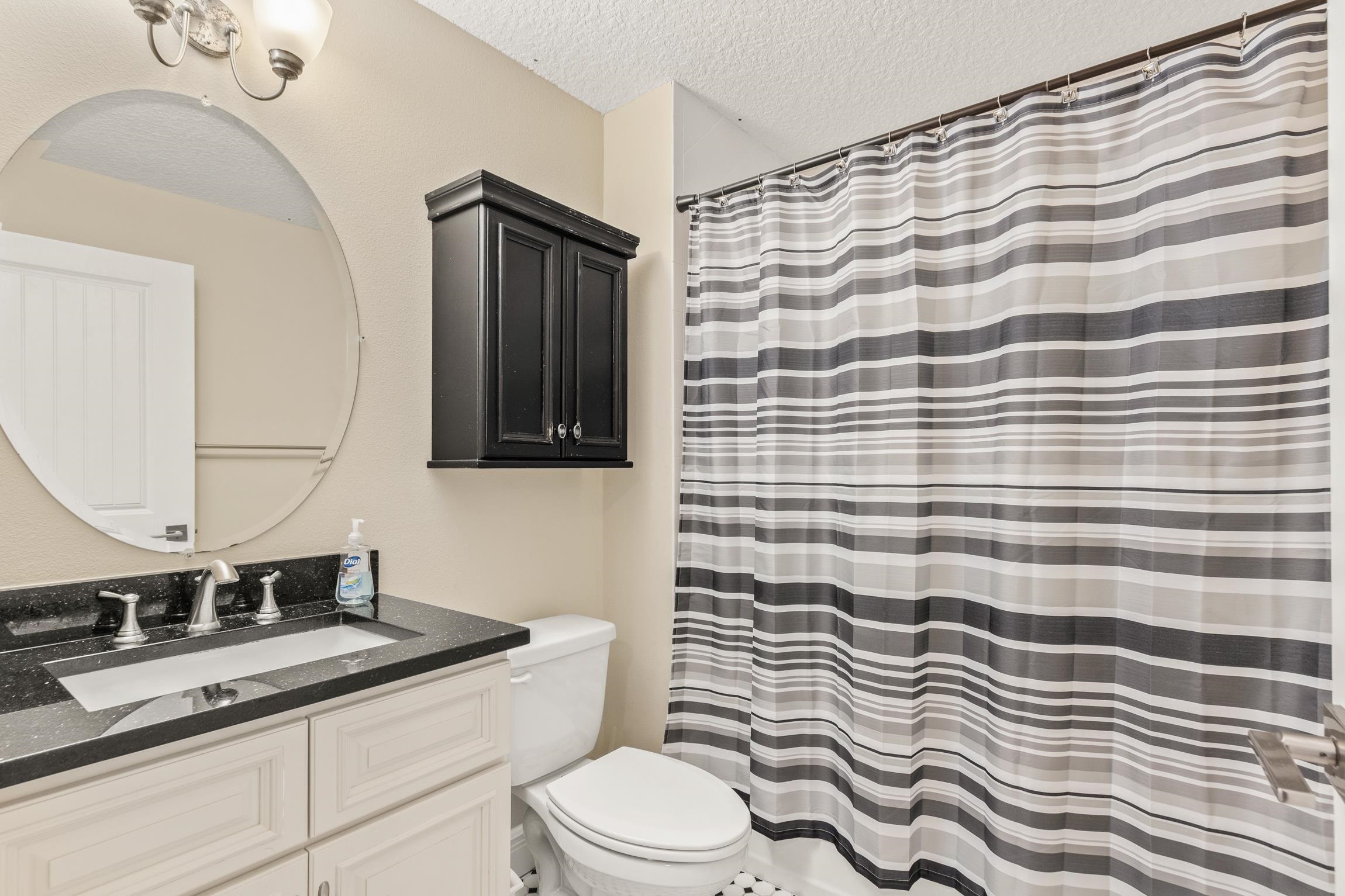 32 Comares Avenue St. Augustine, FL 32080 - Photo 27 of 43 a bathroom with a granite countertop toilet sink and mirror