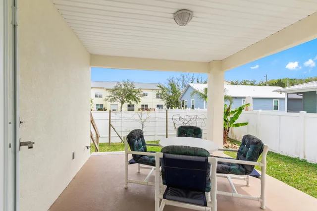 a living room with furniture a fireplace and a floor to ceiling window