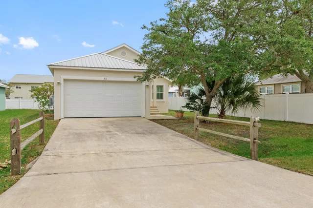 a view of backyard of house with large trees
