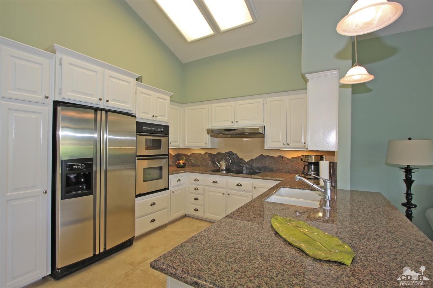 198 Ranch View Circle Palm Desert, CA 92211 - Photo 11 of 54 a kitchen with stainless steel appliances granite countertop a sink refrigerator and cabinets
