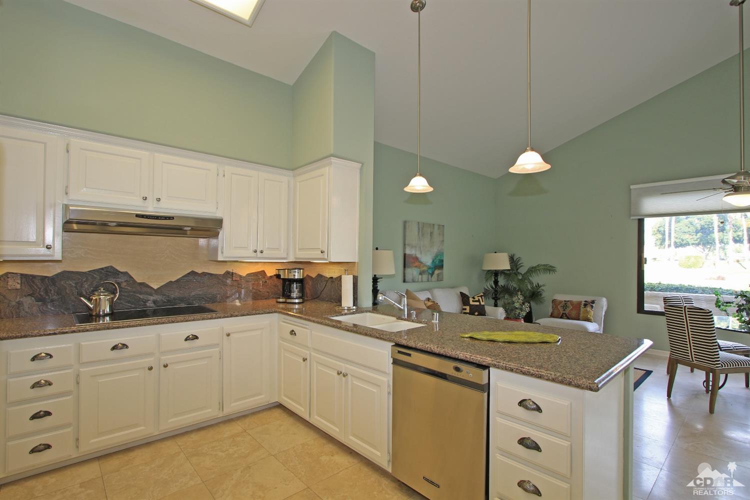 198 Ranch View Circle Palm Desert, CA 92211 - Photo 13 of 54 a kitchen with granite countertop a sink a stove and cabinets