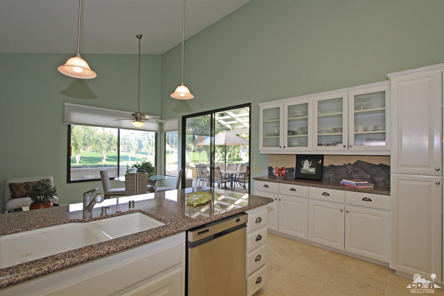 198 Ranch View Circle Palm Desert, CA 92211 - Photo 14 of 54 a kitchen with a sink and a large window