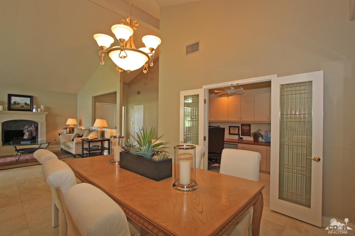 198 Ranch View Circle Palm Desert, CA 92211 - Photo 20 of 54 a dining room with wooden floor a chandelier a wooden table and chairs