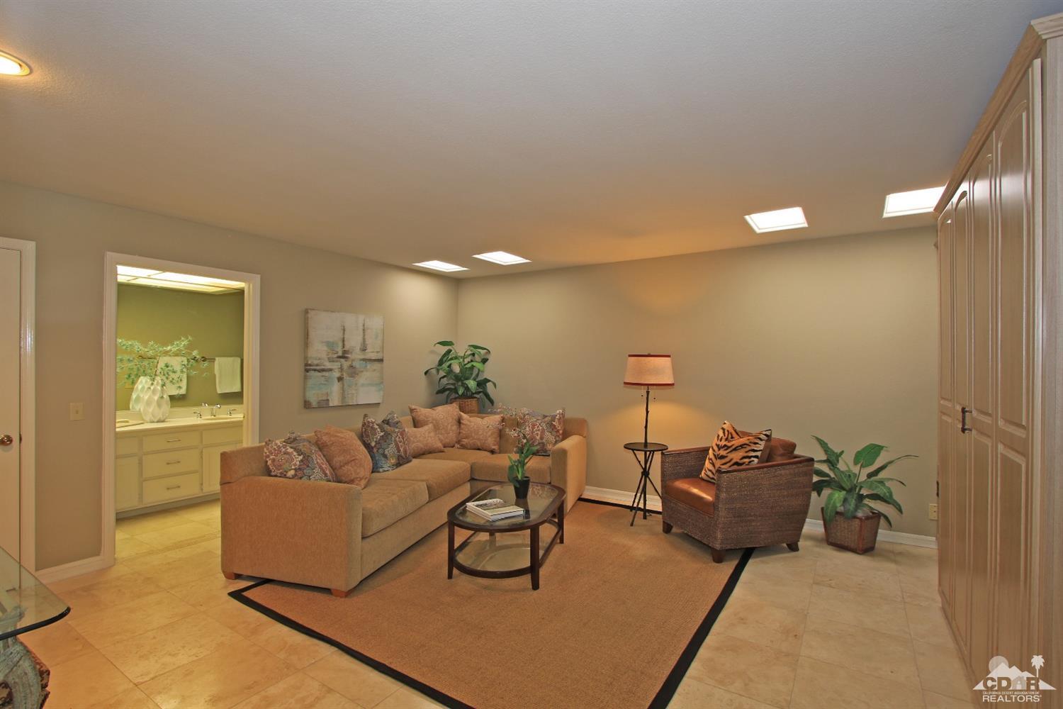 198 Ranch View Circle Palm Desert, CA 92211 - Photo 23 of 54 a living room with furniture and a potted plant