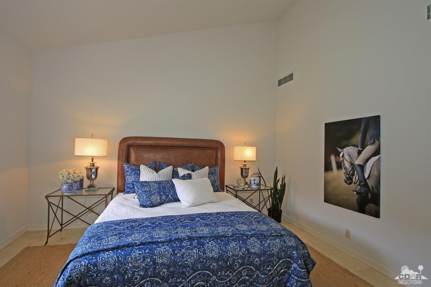 198 Ranch View Circle Palm Desert, CA 92211 - Photo 35 of 54 a bedroom with bed and paintings on the wall