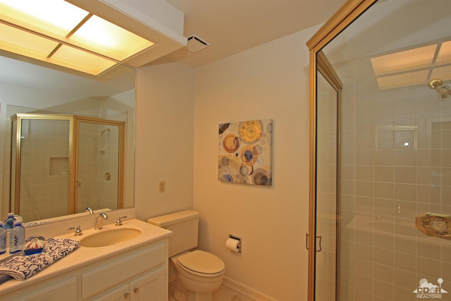 198 Ranch View Circle Palm Desert, CA 92211 - Photo 37 of 54 a bathroom with a granite countertop sink toilet and shower