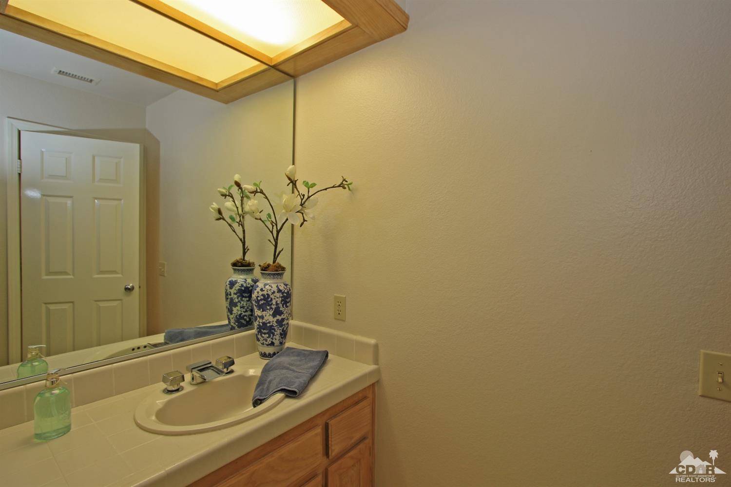 198 Ranch View Circle Palm Desert, CA 92211 - Photo 38 of 54 a bathroom with a sink and a mirror