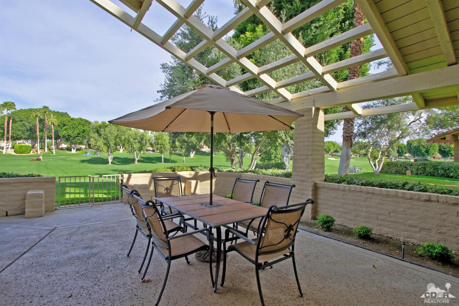 198 Ranch View Circle Palm Desert, CA 92211 - Photo 39 of 54 a view of a patio with a table chairs and a backyard