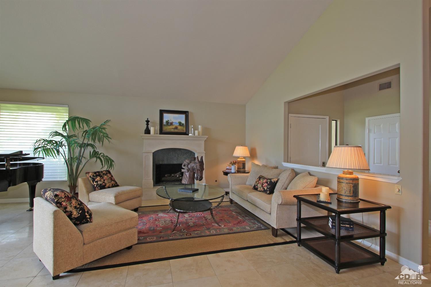 198 Ranch View Circle Palm Desert, CA 92211 - Photo 5 of 54 a living room with furniture a fireplace and a potted plant