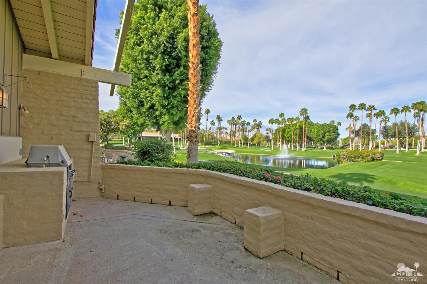 198 Ranch View Circle Palm Desert, CA 92211 - Photo 45 of 54 a backyard of a house with lots of green space and fountain